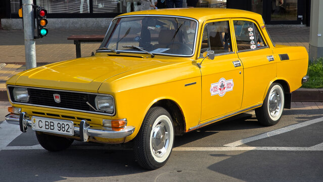 Piatra Neamt, Romania - June 7, 2025: Bright yellow 1982 Moskvitch 2140, a classic Soviet-era car, parked outdoors. The front view highlights its iconic grille and headlights.
