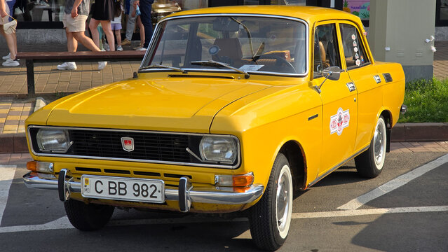 Piatra Neamt, Romania - June 7, 2025: Bright yellow 1982 Moskvitch 2140, a classic Soviet-era car, parked outdoors. The front view highlights its iconic grille and headlights.
