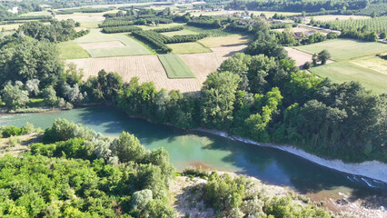 Fototapeta premium Aerial View of Tanaro River Winding Through Lush Piedmont Countryside
