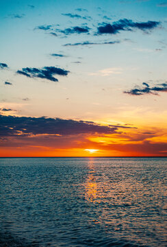 Beautiful sundown background with sea and cloudy blue sky
