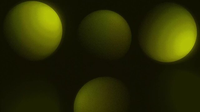 Animation of floating 3D sphere balls with shadows moving and wiggling through an abstract space on a dark gradient background dynamic motion graphics and visual effects vibrant colours yellow gold
