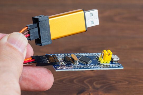 Development board STM and programmer in hand