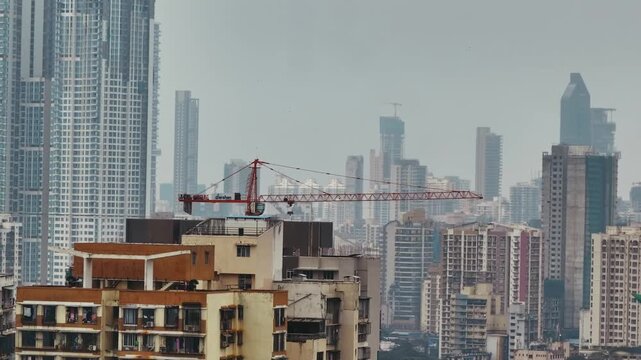 Aerial view of the Mumbai city skyline during the monsoon season near Atal Setu, Sewri, Mumbai, India. The dramatic drone perspective captures rain clouds, misty atmosphere.