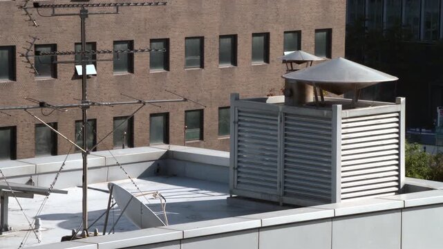 Steam rising from a vent beside a modern building