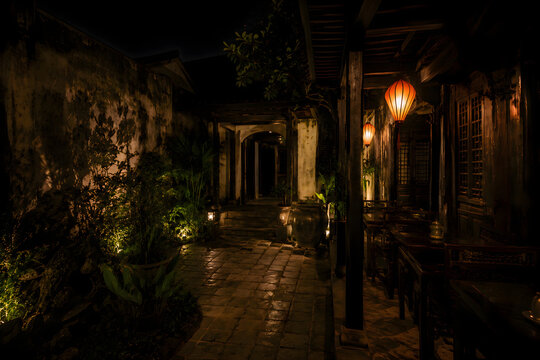 Dramatic Night Atmosphere Vietnamese Ancient Shophouse Passage with Warm Lanterns