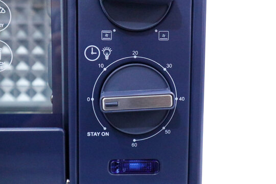 Close up of a dark blue electric oven control panel showing a rotary timer selector knob with a minutes scale pointed to the forty minute setting