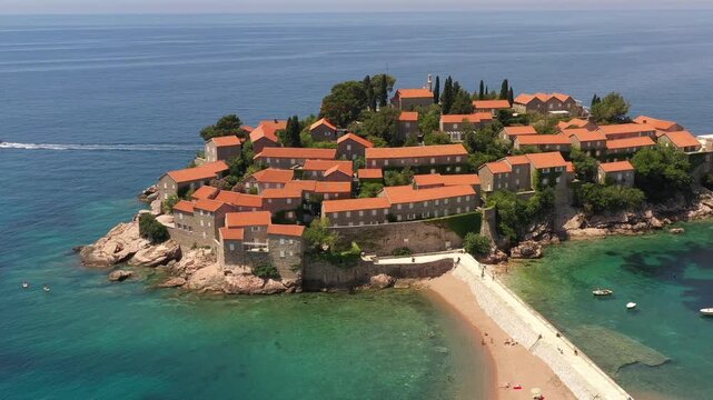 Aerial scenic view of Sveti Stefan island resort surrounded by turquoise Adriatic sea water in Montenegro.