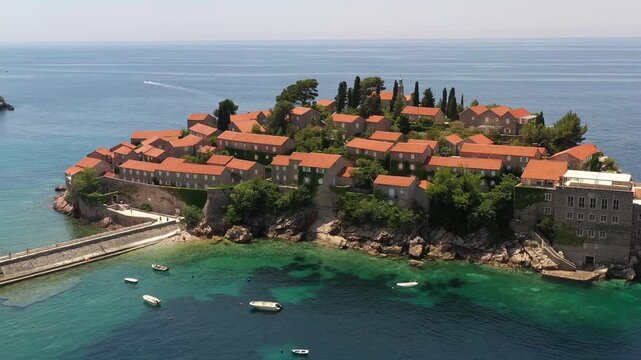 Aerial scenic view of Sveti Stefan island resort surrounded by turquoise Adriatic sea water in Montenegro.