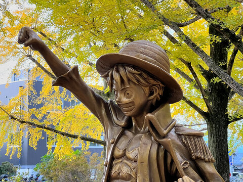 Kumamoto, Japan - November 20, 2025 : A bronze statue of the character Monkey D. Luffy from the popular anime and manga series One Piece at Kumamoto Prefectural Government Office, Kumamoto, Japan