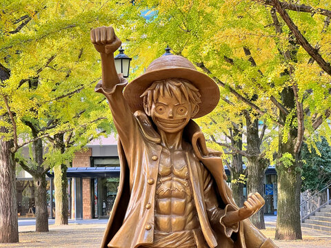 Kumamoto, Japan - November 20, 2025 : A bronze statue of the character Monkey D. Luffy from the popular anime and manga series One Piece at Kumamoto Prefectural Government Office, Kumamoto, Japan
