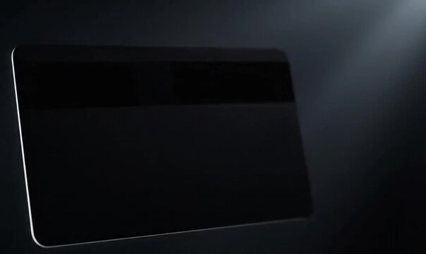 A blank plastic credit card with a gold chip floats against a dark background, symbolizing financial transactions and digital payments.