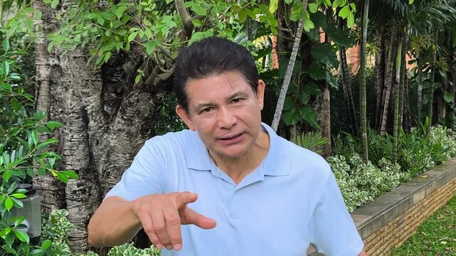 Angry asian senior man shouting or screaming out loud at you