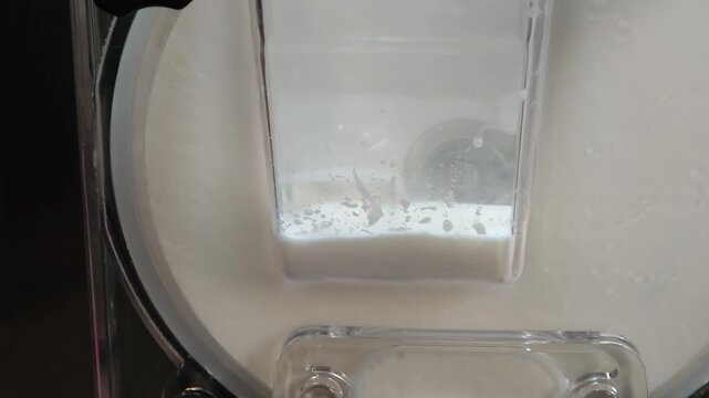 ice cream coming out of the ice cream maker. freshly made homemade ice cream