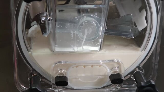 ice cream coming out of the ice cream maker. freshly made homemade ice cream