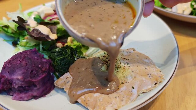Sous vide chicken breast served with baked mashed sweet potato and fresh vegetables.