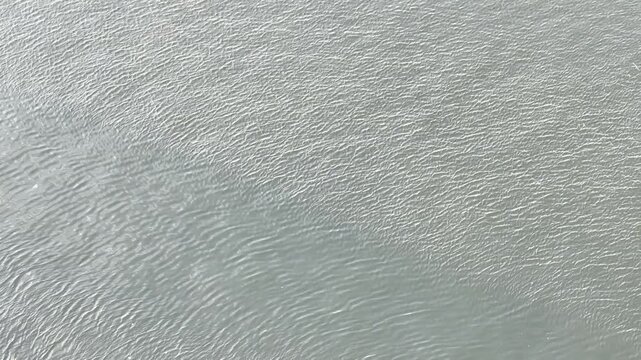 Wave ripples on a river's surface are small waves, often called capillary waves. Ala Wai Canal is an artificial waterway in Honolulu, Oahu, Hawaii. northern boundary of the tourist district of Waikiki