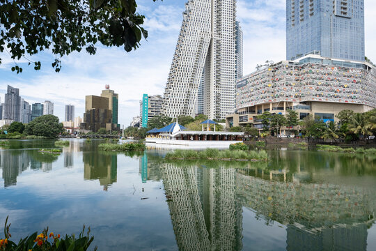 12.10.2025 Colombo, Sri Lanka. Modern skyscrapers and park pavilion reflecting in Beira Lake in Colombo.