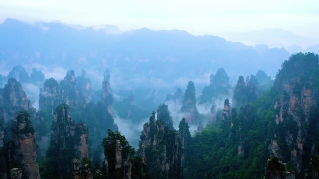 Limestone karst pillar at Wulingyuan Zhangjiajie China with ethereal mist haze for nature travel tourism background