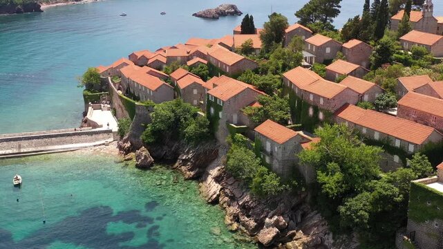 Aerial scenic view of Sveti Stefan island resort surrounded by turquoise Adriatic sea water in Montenegro.