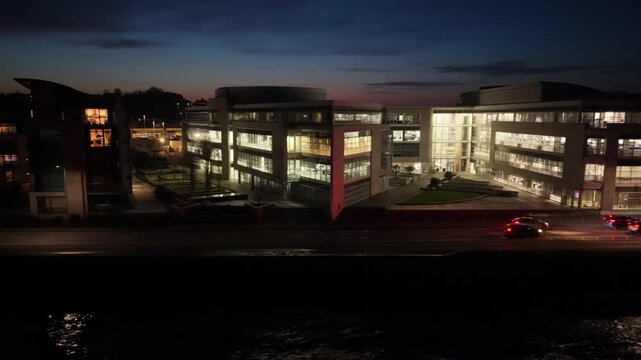Admiral Park St Peter Port Guernsey.Drone footage of Les Banques by night flying parallel to Les Banques showing Vega Apartments,Martello Court and Dorey Court lit up at night with traffic passing by
