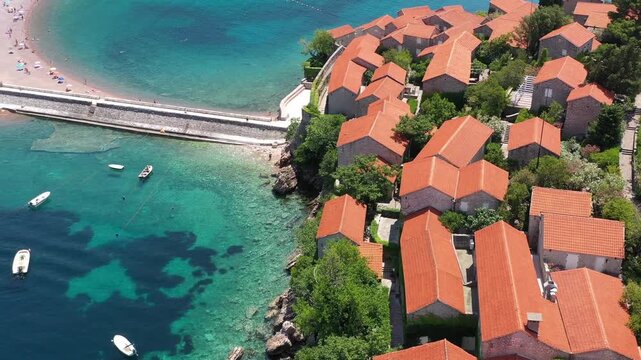 Aerial scenic view of Sveti Stefan island resort surrounded by turquoise Adriatic sea water in Montenegro.