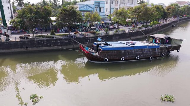 Cargo Boat Scenes. Midday Activity Shows Busy Riverside Market And Shipping Dock. Aerial View Capturing Bustling Markets And Cargo Operations Along Can Tho Waterway During Midday