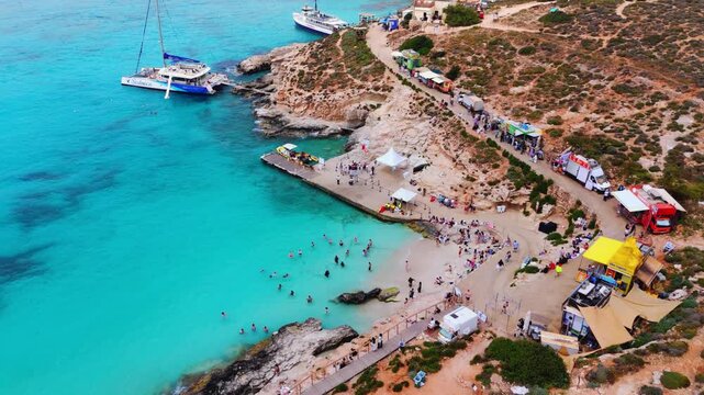 The Blue Lagoon is a highly popular, shallow strait between Comino and Cominotto in Malta, celebrated for its brilliant turquoise waters and sandy seafloor. It is a major destination for swimming,