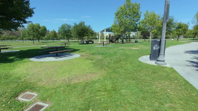 A steady cam shot of a playground in a public park