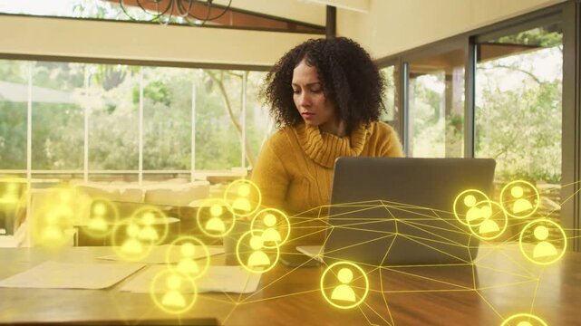 Woman glancing right, sorting doc, typing for work while yellow network icons animating over laptop