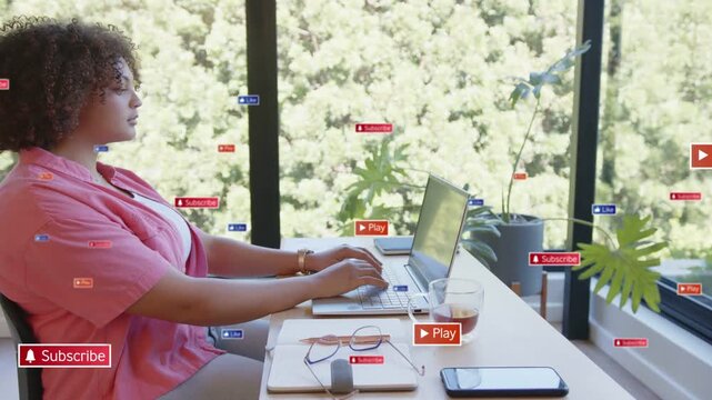Woman typing on laptop sparking play or subscribe icons for social, pausing, taking break, sipping m