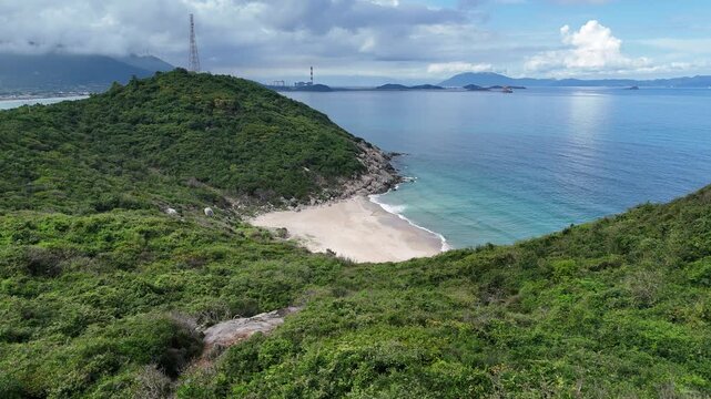 Drone flyover toward secluded beach and tropical coastline in Ninh Phuoc, Khanh Hoa, Vietnam