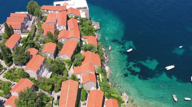 Aerial scenic view of Sveti Stefan island resort surrounded by turquoise Adriatic sea water in Montenegro.
