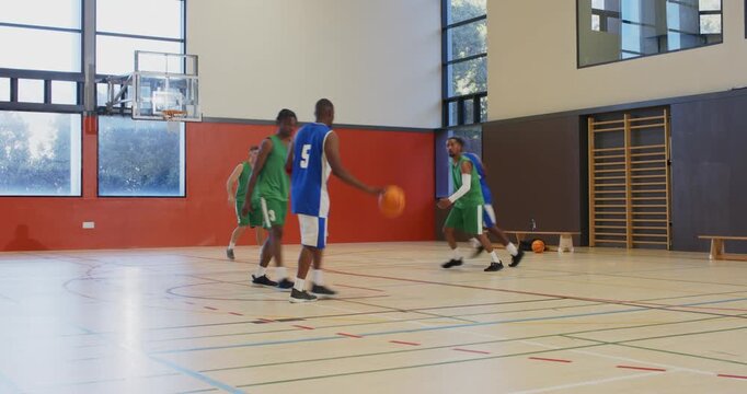 Gym, blue teammates passing to 5 driving layup, blocking, rebound tipping into hoop, copy space