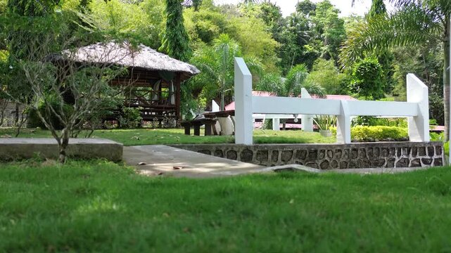 Tropical resort garden with gazebo and lush greenery near the beach in Sabang, Pulau Weh, Aceh, Indonesia. Peaceful vacation destination surrounded by tropical landscape.