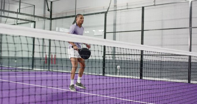 Man training on court with paddle lunging forehand volley switching backhand leaping smash