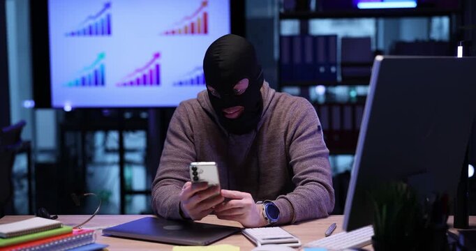 Emotional scammer in mask threatens to user by video call in office. Internet fraud angry over illegal deal fell through via cellphone at desk