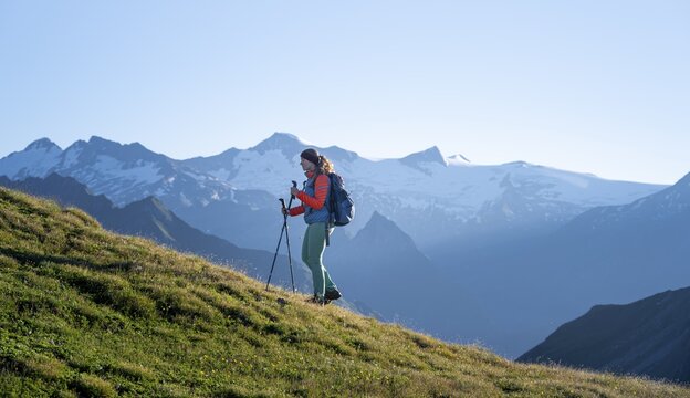 Hiker enjoying the mountain panorama in the morning, Venediger group, behind Dreiherrenkopf, Simonysitze and Gro&szlig;er Geiger, Hohen Tauern, Austria