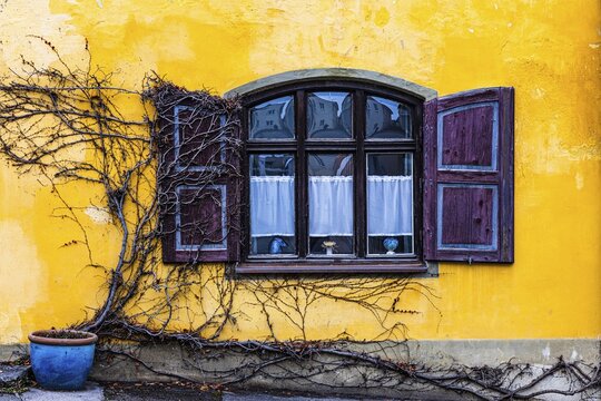 Round arch window with shutters with yellow fa&ccedil;ade, Die&szlig;en am Lake Ammer, Upper Bavaria, Bavaria, Germany