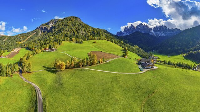 Farm and alpine meadows, in the background the peaks of the Geisler group, panoramic shot, drone shot, Sankt Magdalena, Villn&ouml;&szlig;tal, Dolomites, Autonomous Province of Bolzano, South Tyrol, Italy