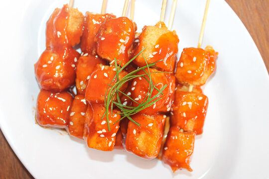 Indonesian spicy grilled fish cakes satay with sesame seeds