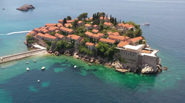 Aerial scenic view of Sveti Stefan island resort surrounded by turquoise Adriatic sea water in Montenegro.