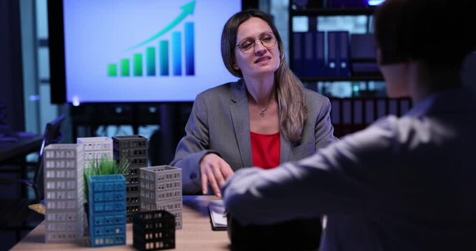 Woman customer takes money for real estate pavement out of purse at meeting with agent in office. Female buys modern commercial buildings in agency