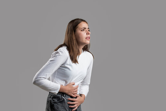 Woman suffering from abdominal pain. Woman stomach ache. Woman touching his stomach. Stomach pain and others stomach disease concept. Girl having a stomachache