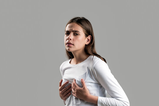 Woman suffering from chest pain. Woman having heart attack. Heart attack concept. Girl feeling heart pain and holding her chest. Healthcare and medical concept. Girl holding hand chest pain