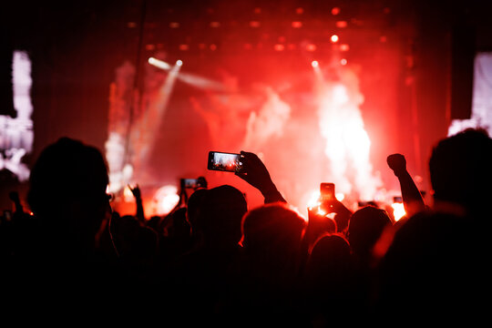 Vertical Silhouette of Kid on Shoulders at Blue Concert