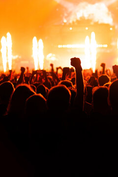 Silhouette of Crowds Cheering at Orange Concert Stage