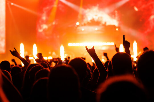 Silhouette of Crowds with Hands Raised at Live Concert