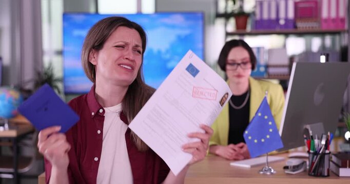Disappointed woman applicant sits in modern visa center. Emotional female examines documents after receiving refusal for visa to European Union