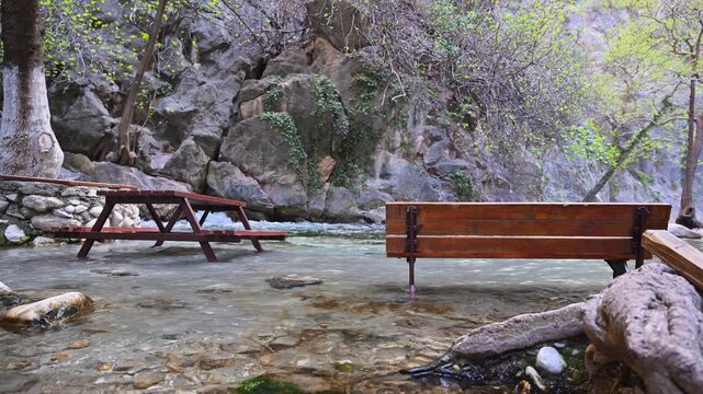 Wooden benches inside a flowing river at Saklikent Canyon in Turkey