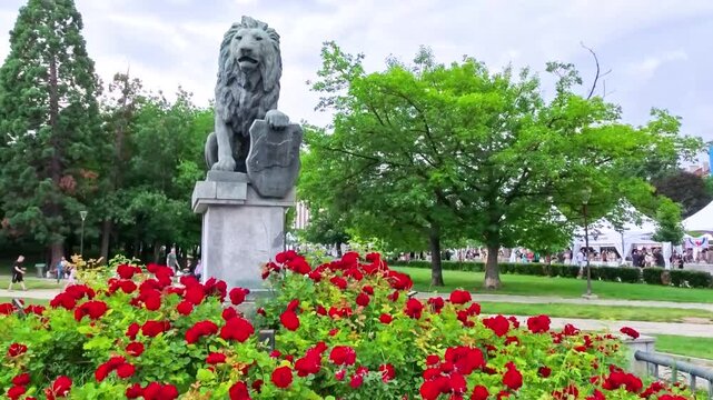 Sofia, Bulgaria - 06.06.2026. Annual Book Fair in front of the National Palace of Culture NDK. Lion statue with red roses, Bulgarian publishers from across the country present books for exhibition and